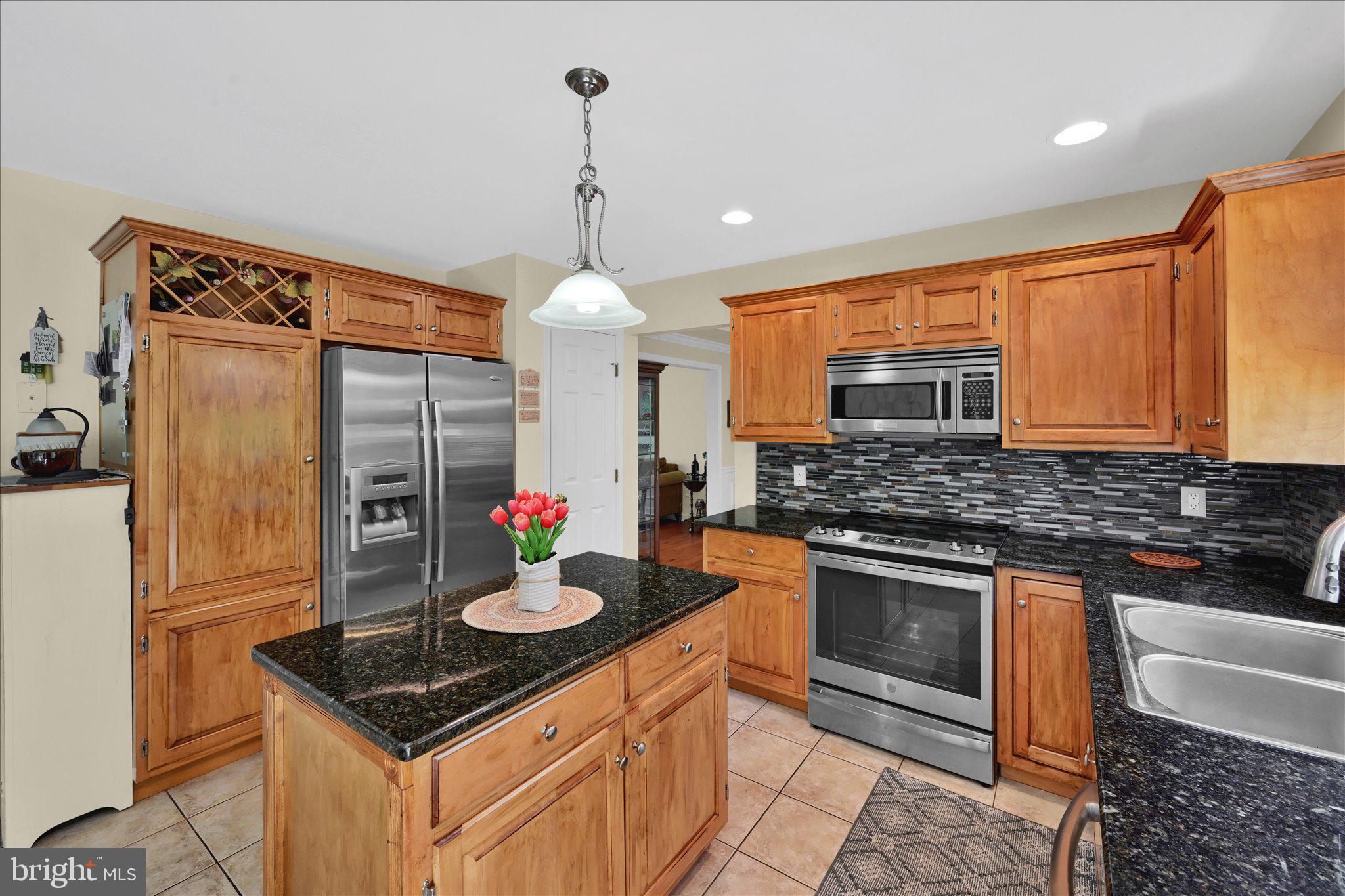 624 Stoney Run Road Pottsville, PA 17901 - Photo 11 of 40 a kitchen with stainless steel appliances granite countertop a stove and a refrigerator