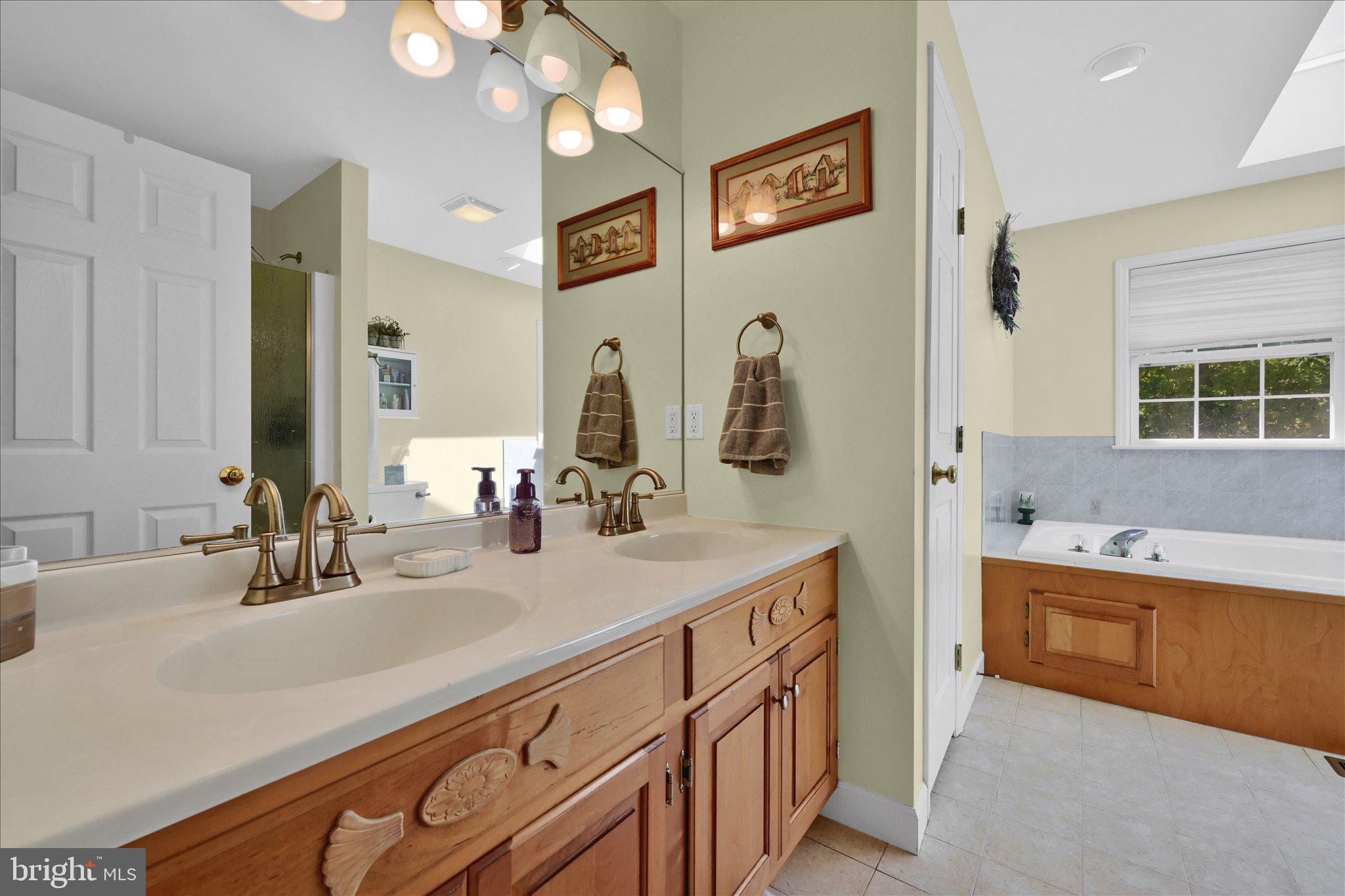 624 Stoney Run Road Pottsville, PA 17901 - Photo 23 of 40 a bathroom with a sink double vanity granite tub shower and a mirror