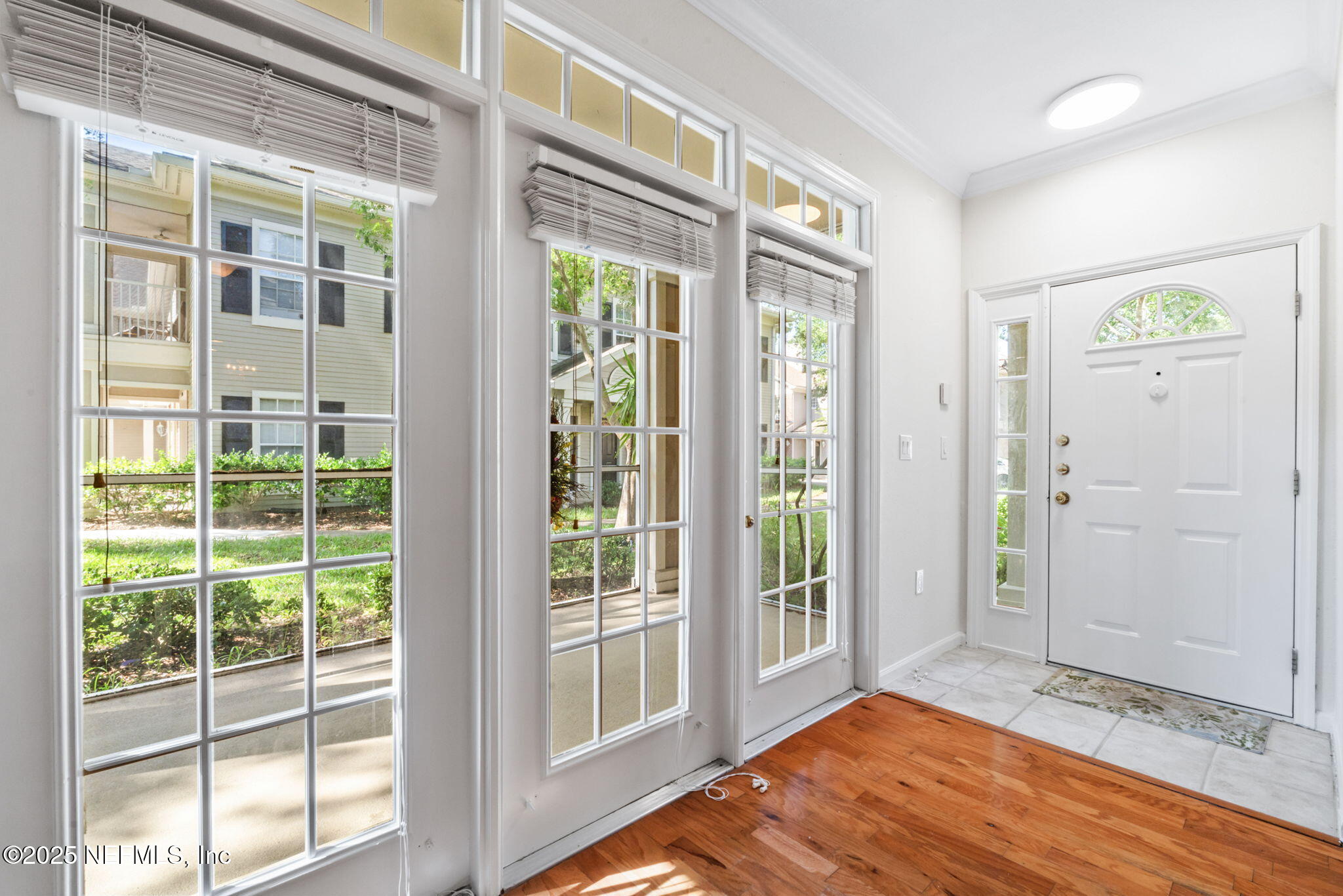 10901 Burnt Mill Road, Unit 2204 Jacksonville, FL 32256 - Photo 6 of 49 a view of an entryway with wooden floor and door