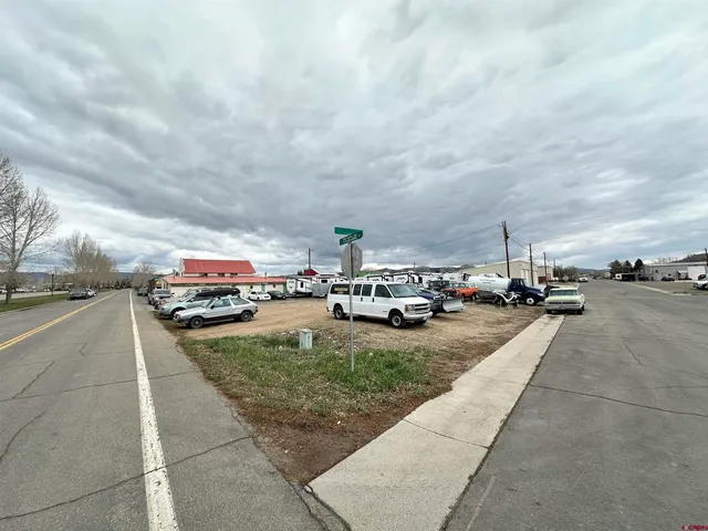 a view of a yard with cars park
