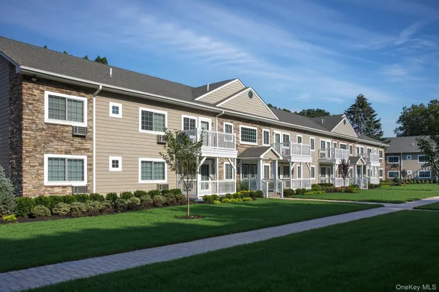a front view of building with yard play and green space