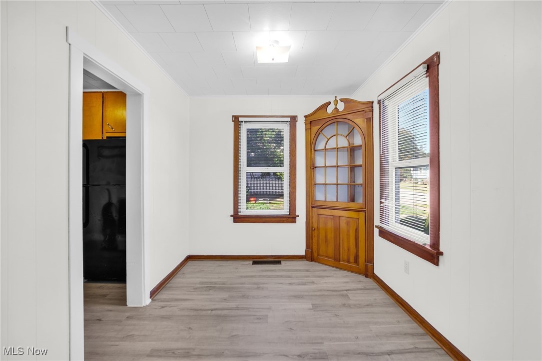 17 Ganyard Street Rittman, OH 44270 - Photo 5 of 16 Foyer featuring light wood finished floors, ornamental molding, and plenty of natural light