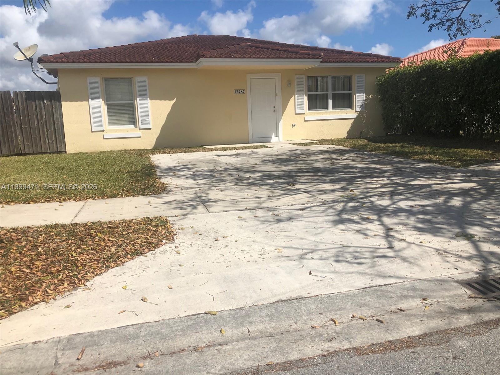 12787 Southwest 257th Street, Unit 12787 Homestead, FL 33032 - Photo 1 of 5 a front view of a house