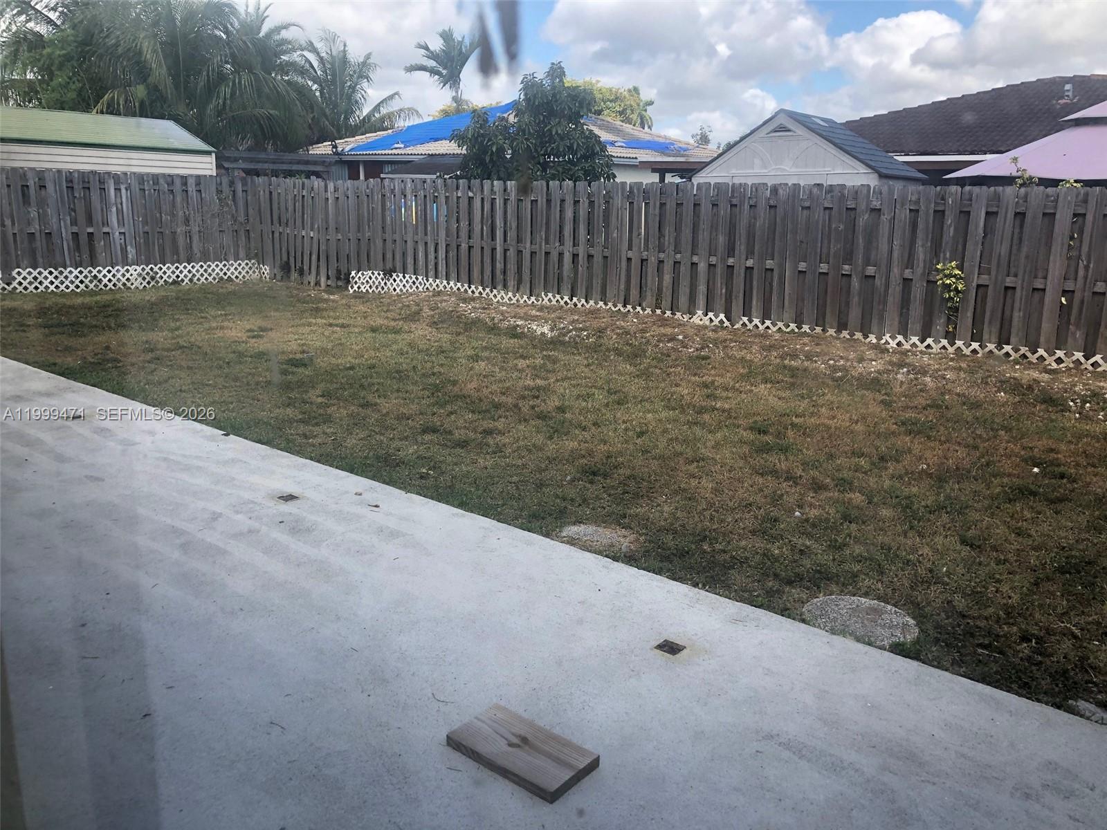 12787 Southwest 257th Street, Unit 12787 Homestead, FL 33032 - Photo 2 of 5 a view of a backyard