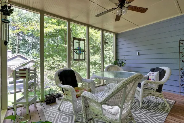 a living room with furniture and floor to ceiling windows