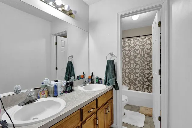 a bathroom with a sink double vanity and a mirror