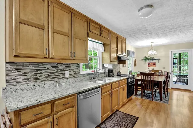 a kitchen with stainless steel appliances granite countertop a sink and cabinets