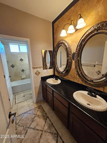 a bathroom with a toilet a sink and a mirror
