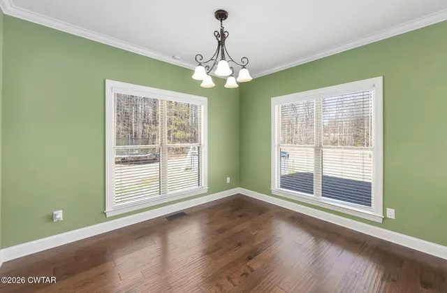 a view of wooden floor and chandelier in a room