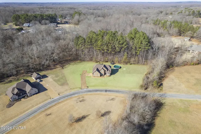 a view of a pool with a yard