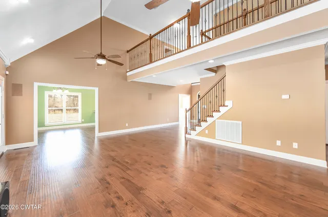 a view of an entryway with wooden floor