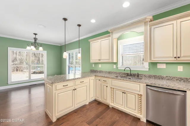 a kitchen with a sink window and cabinets