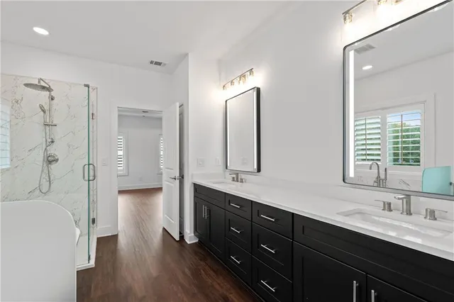 a view of hallway with wooden floor and cabinets