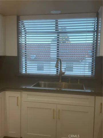 a close view of sink and cabinets