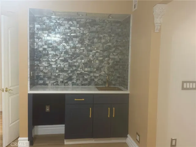 a kitchen with a sink and refrigerator