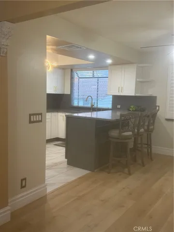 a kitchen with granite countertop a stove a sink and a microwave