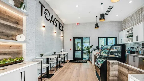 a view of a patio with a table and chairs under an umbrella