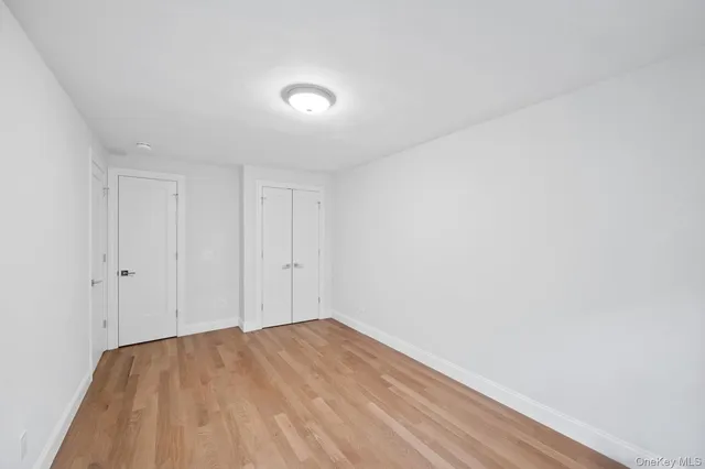 a view of a room with wooden floor and window