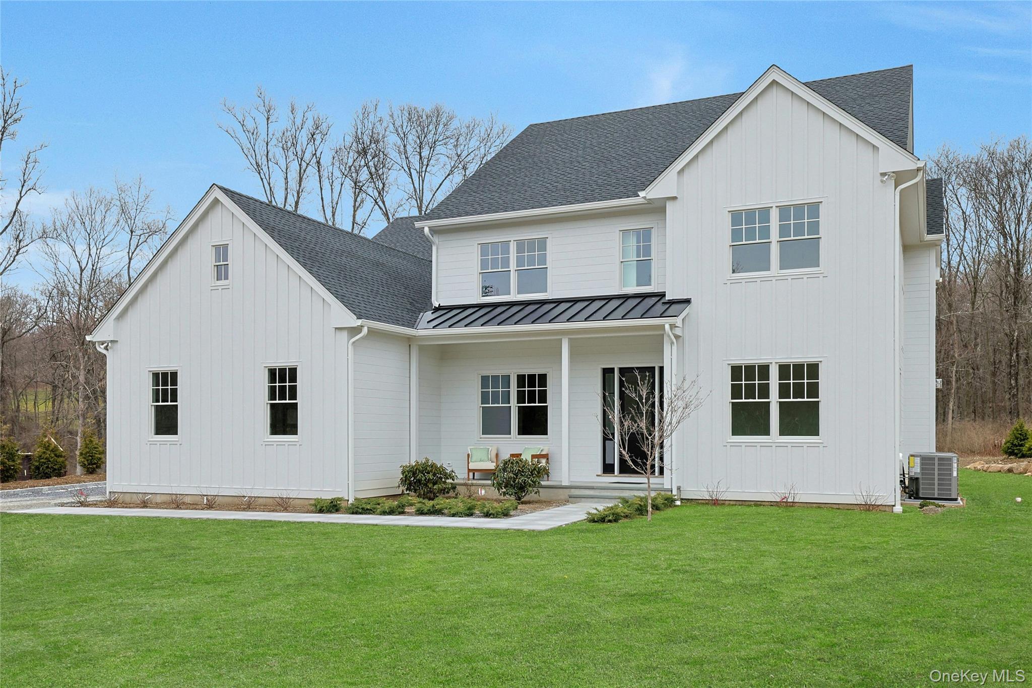 86 Old Byram Lake Road Armonk, NY 10504 - Photo 2 of 44 a view of a white house next to a yard with potted plants
