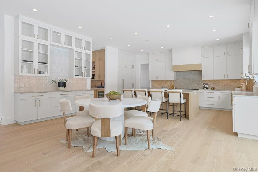 86 Old Byram Lake Road Armonk, NY 10504 - Photo 22 of 44 a large white kitchen with a table and chairs