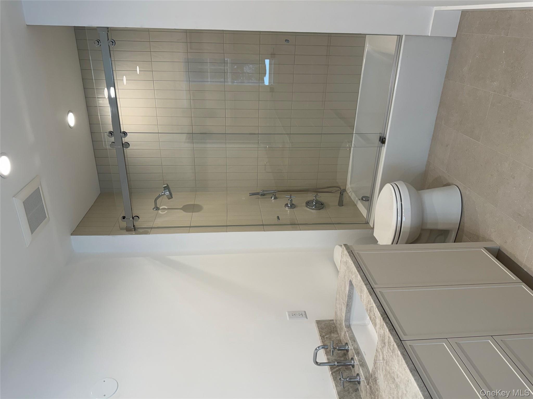 86 Old Byram Lake Road Armonk, NY 10504 - Photo 35 of 44 a bathroom with a granite countertop sink a toilet and shower