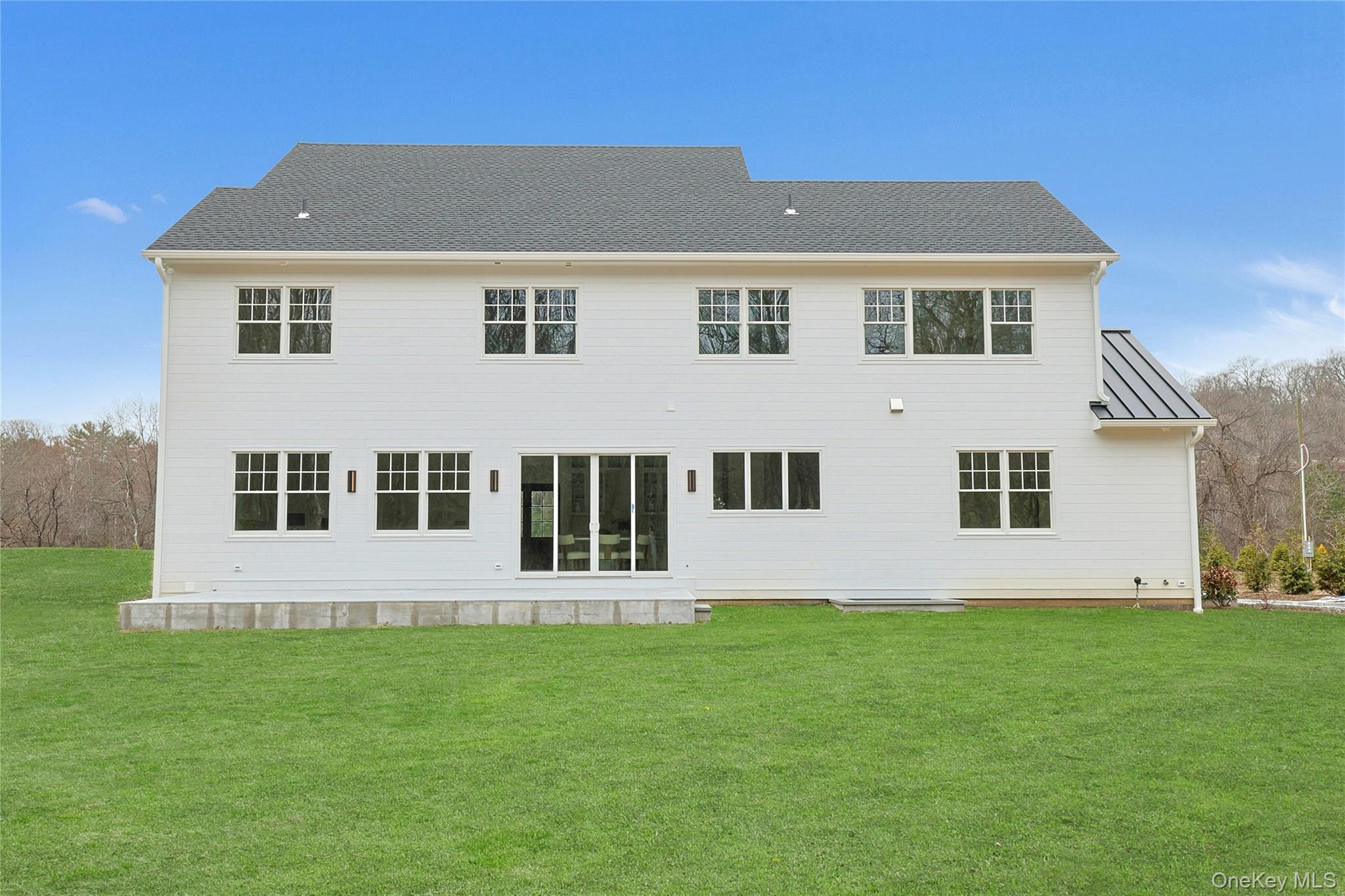 86 Old Byram Lake Road Armonk, NY 10504 - Photo 40 of 44 a front view of a house with a yard