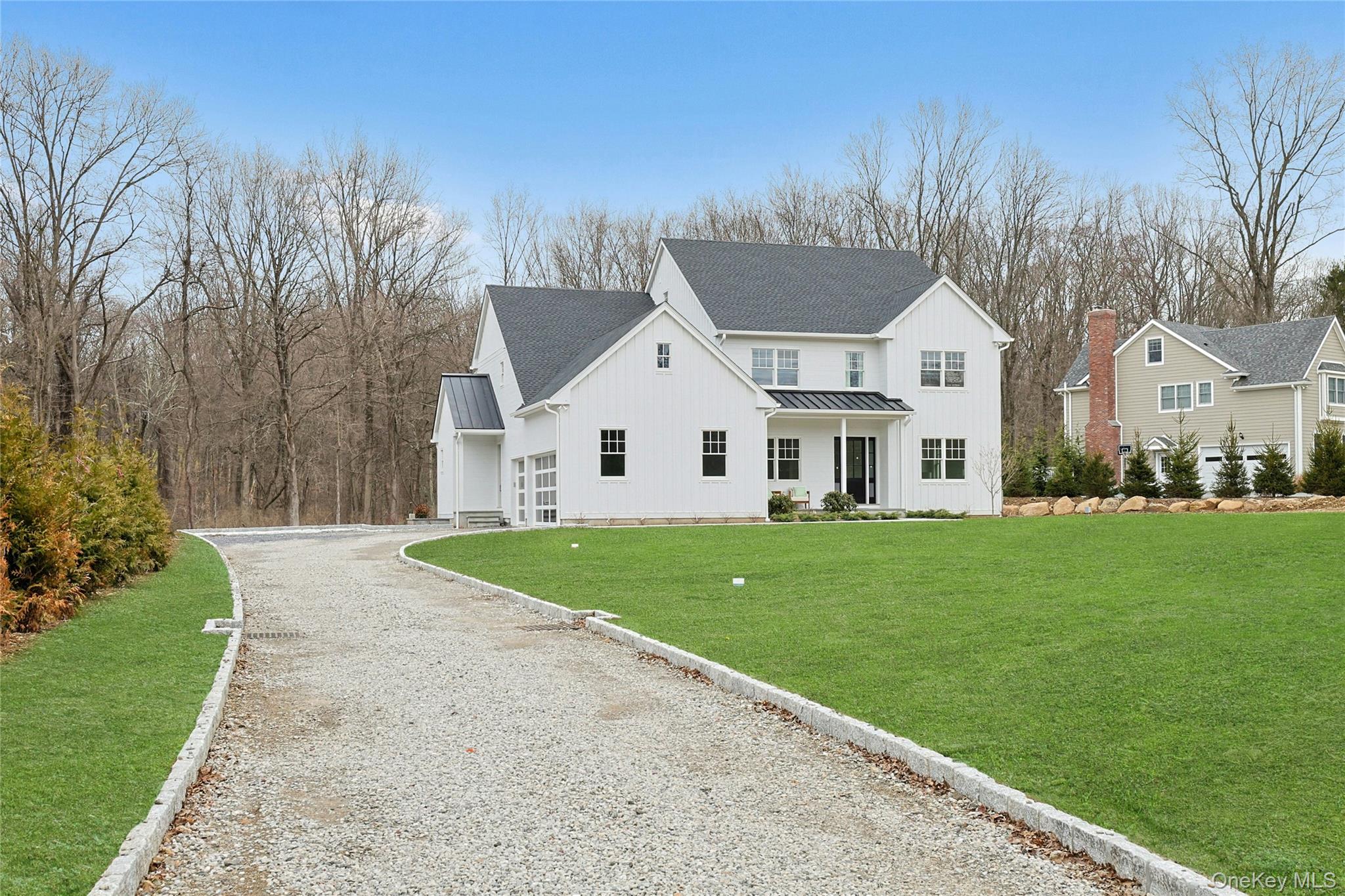 86 Old Byram Lake Road Armonk, NY 10504 - Photo 4 of 44 a view of a yard in front of a house with large trees