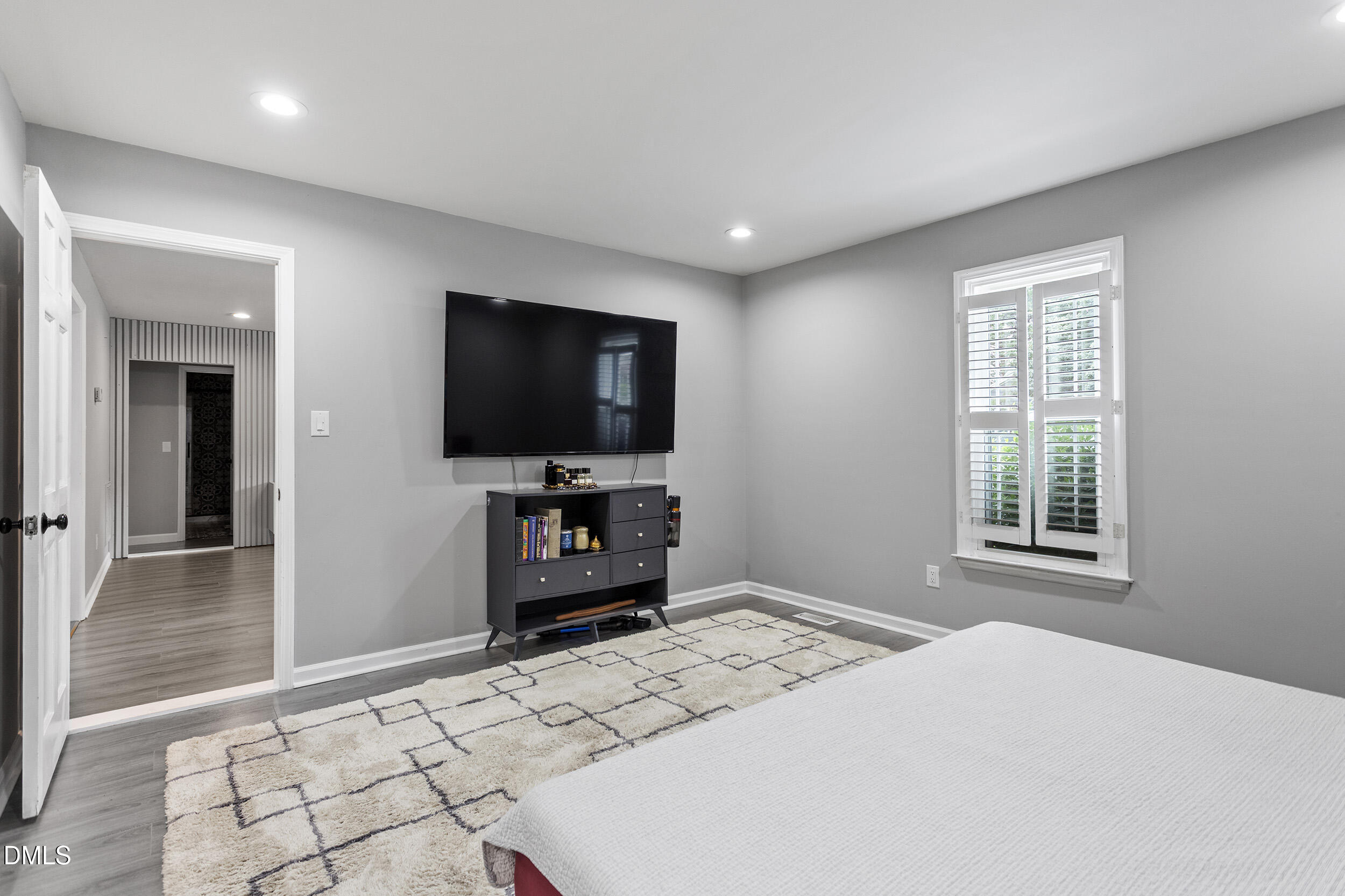 5809 Iris Lake Court Raleigh, NC 27604 - Photo 22 of 29 a bedroom with a bed and a flat screen tv