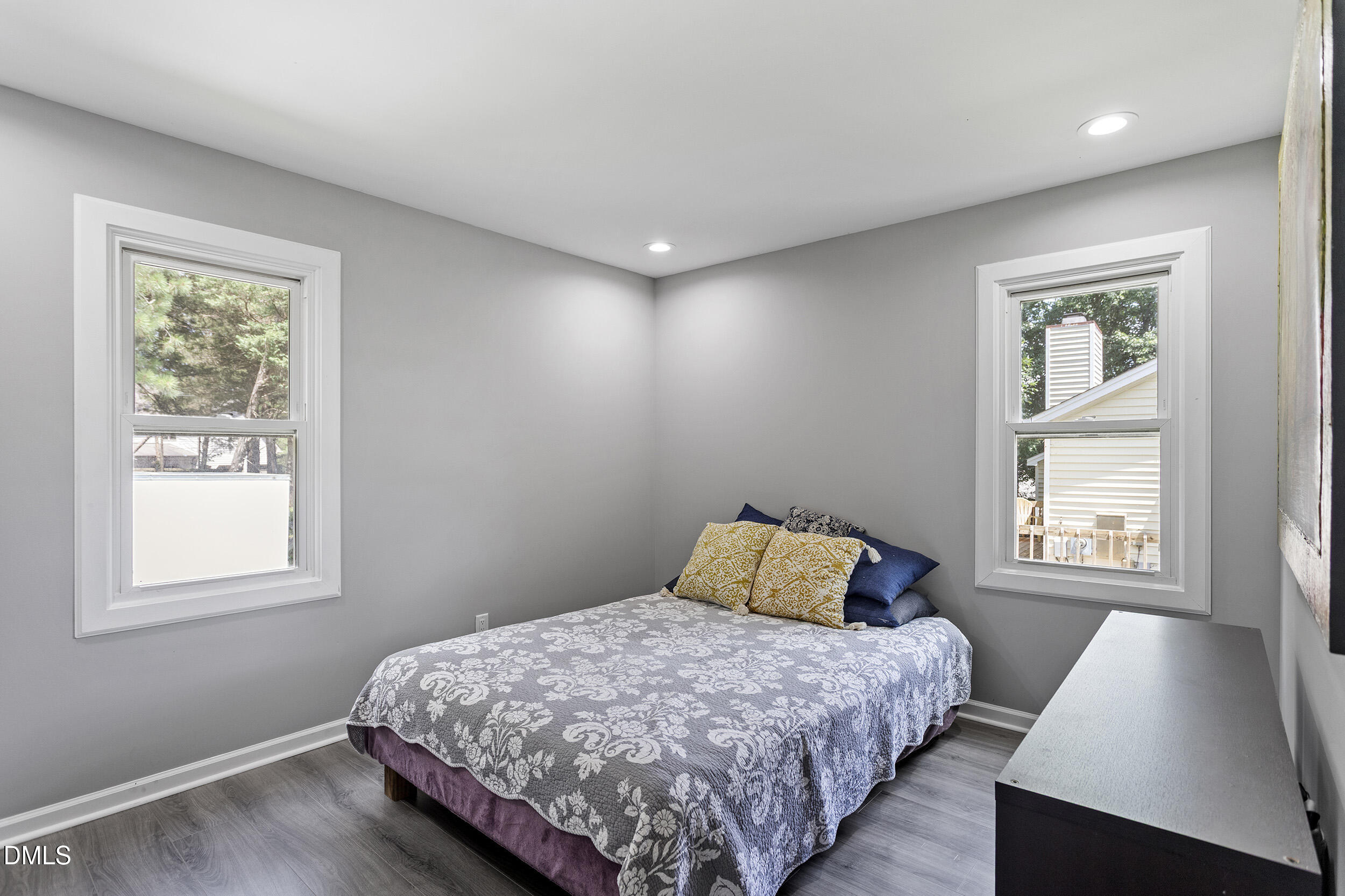 5809 Iris Lake Court Raleigh, NC 27604 - Photo 27 of 29 a bedroom with a bed and wooden floor