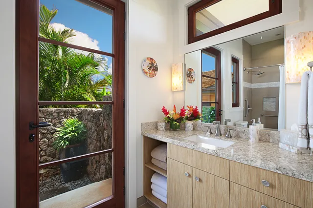 a bathroom with a granite countertop sink and a mirror