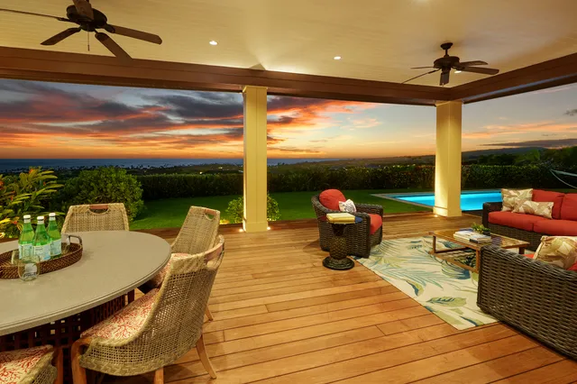 a roof deck with table and chairs
