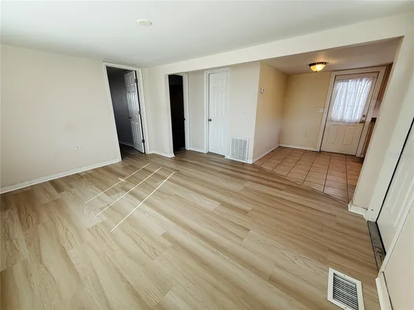 a view of an empty room and wooden floor