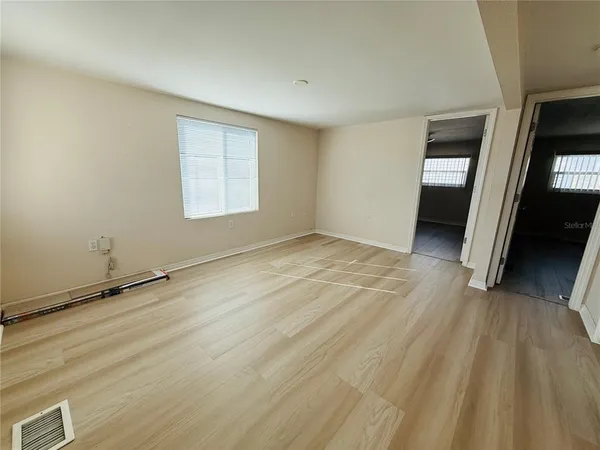 wooden floor in an empty room with a window