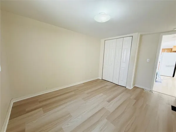 a view of an empty room and wooden floor