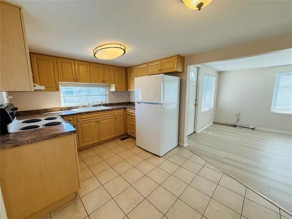 a kitchen with a refrigerator a stove top oven a sink and dishwasher