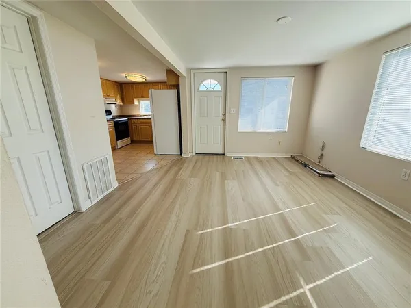 a view of a room with wooden floor and a sink