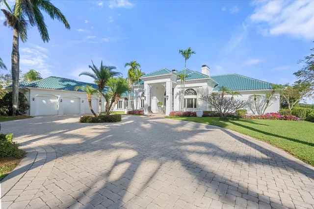 a view of a white house with a yard