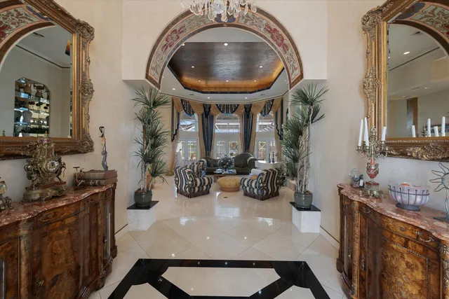 a living room with furniture and a chandelier