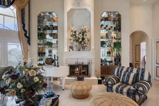 a living room with furniture a fireplace and a large window
