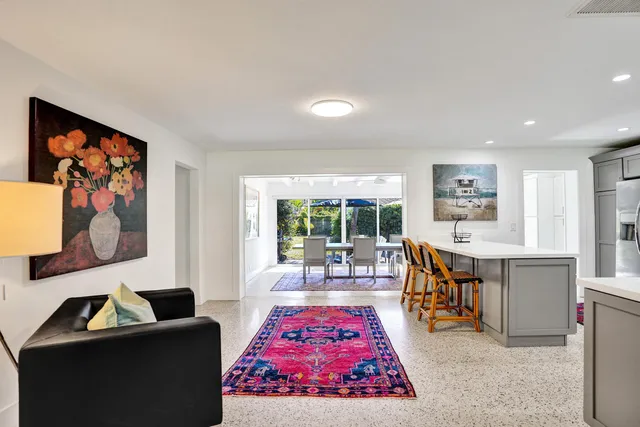 a living room with furniture a rug and a large window