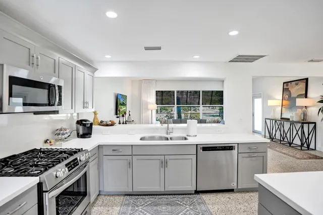 a kitchen with a sink stove top oven and cabinets