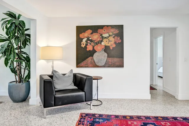 a living room with furniture potted plant and a lamp