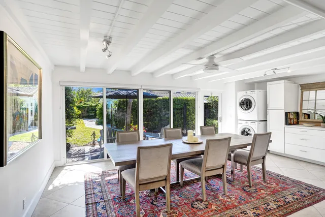 a dining room with wooden floor and a rug