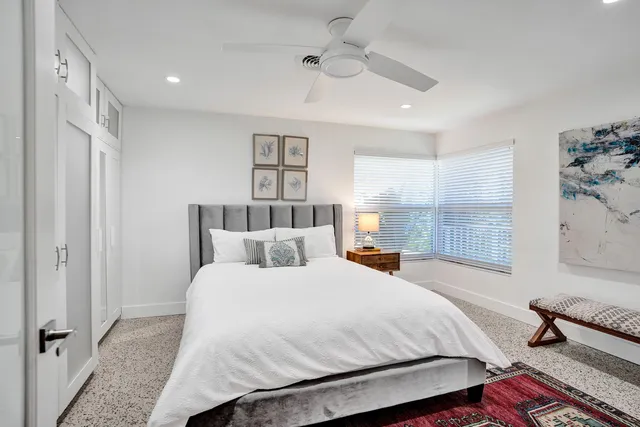 a bedroom with a large bed and a chandelier
