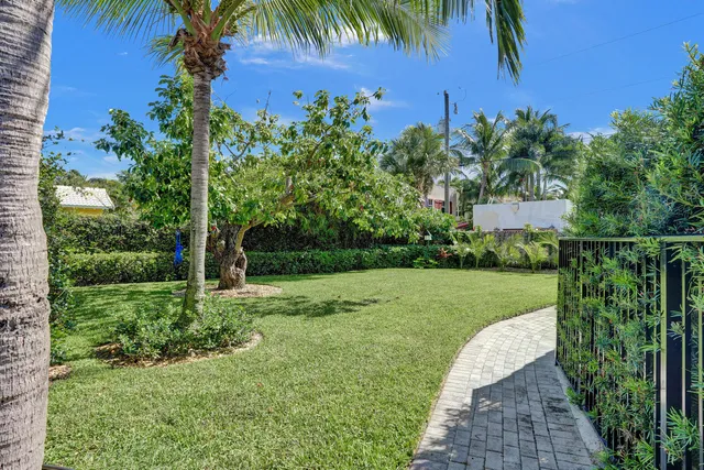 a view of a garden with a building in the background