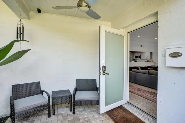 a kitchen with a refrigerator and table chair