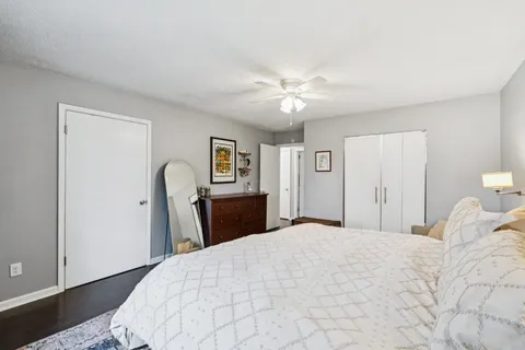 a bedroom with a large bed and a chandelier