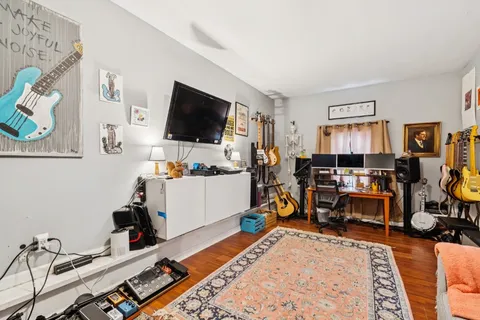 a bed room with furniture and a flat screen tv