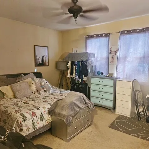 a bedroom with a bed and a chair