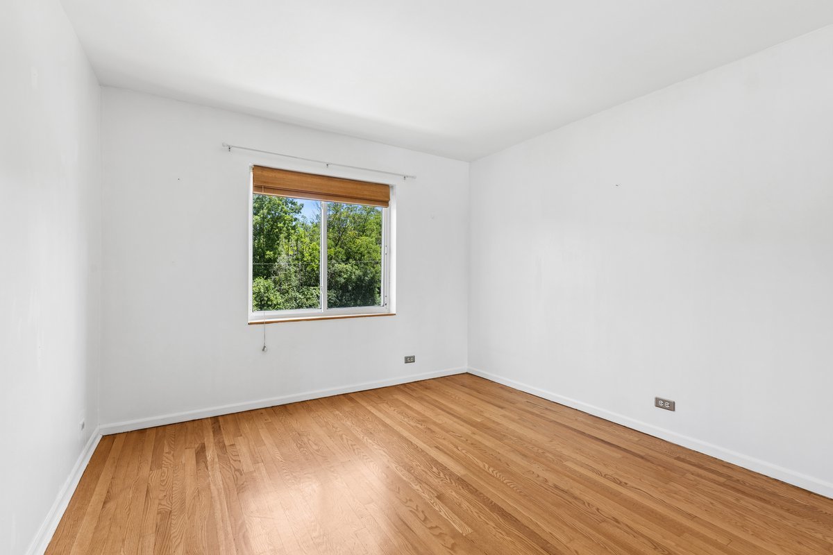 140 Green Bay Road, Unit 2 Glencoe, IL 60022 - Photo 16 of 28 a view of empty room with wooden floor and fan
